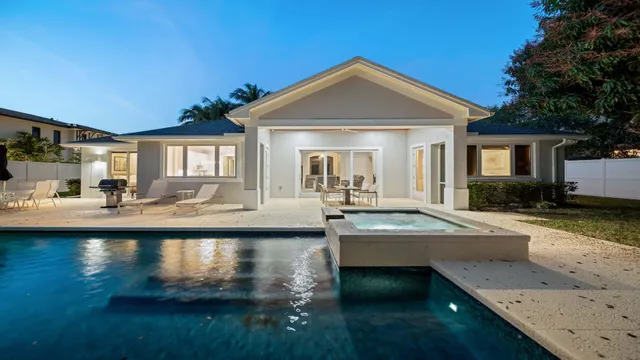a view of a house with swimming pool and sitting area