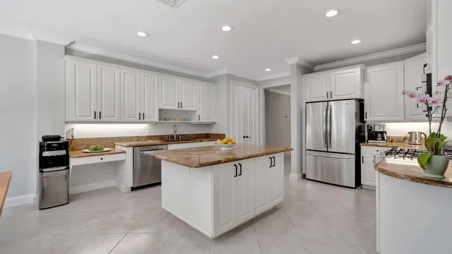 a kitchen with granite countertop a stainless steel appliances and cabinets