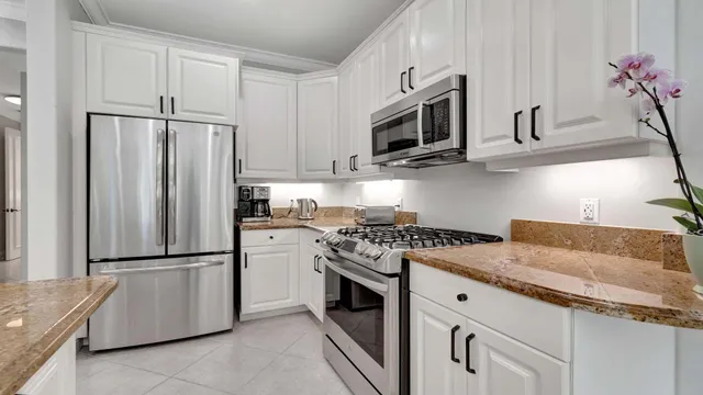 a kitchen with granite countertop appliances cabinets and furniture