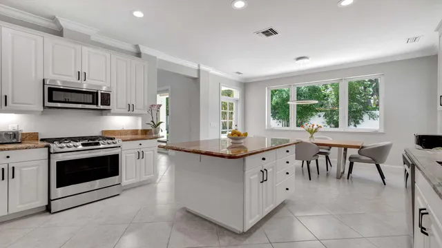 a view of a dining room with furniture and a window