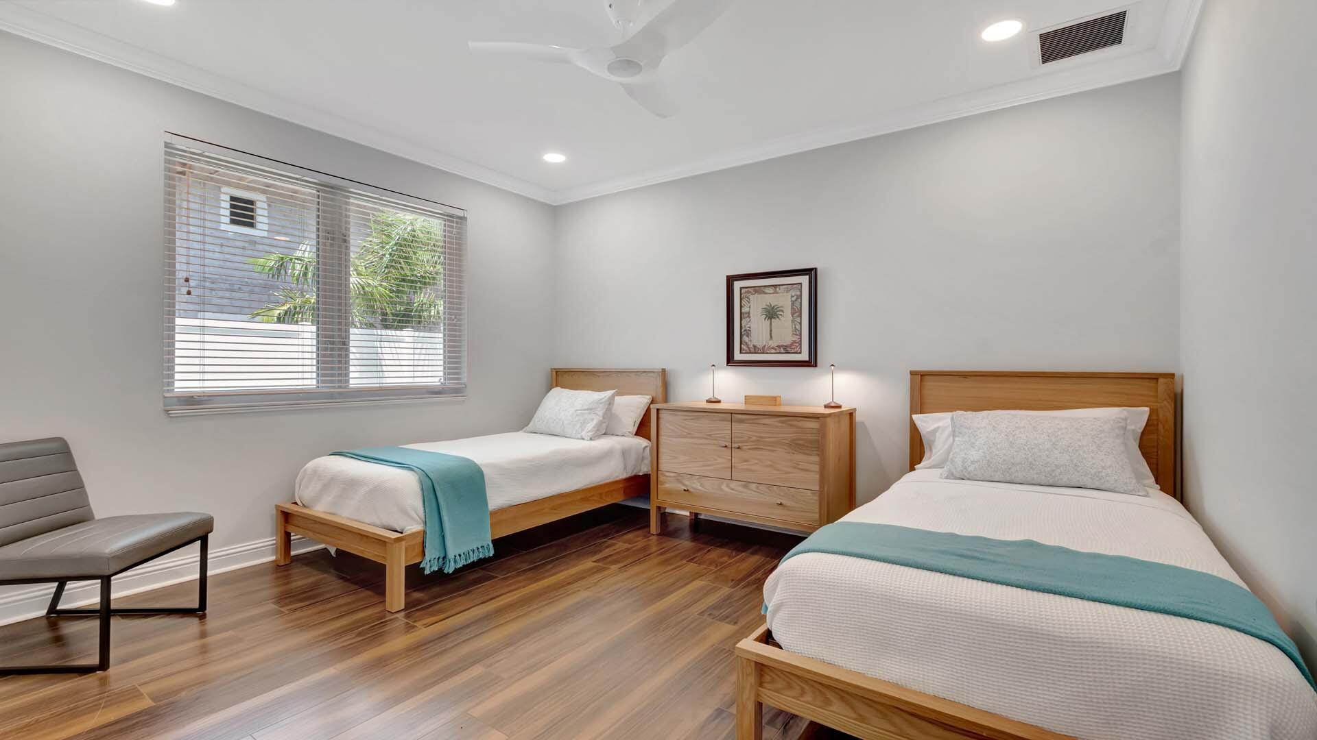 514 Northwest 13th Street Delray Beach, FL 33444 - Photo 25 of 35 a bedroom with two beds and a chair