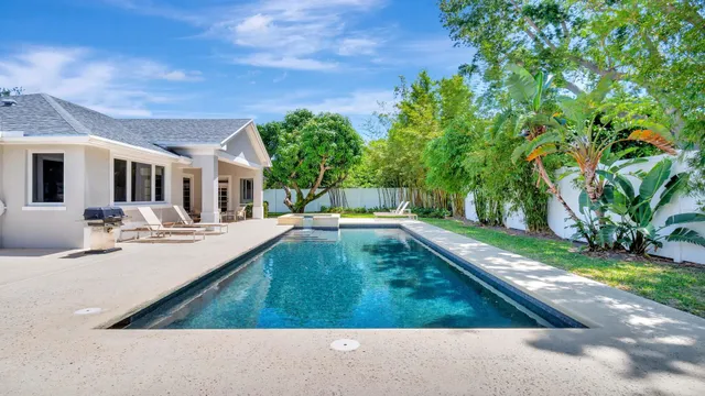 a view of a patio with swimming pool table and chairs