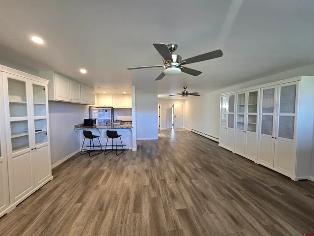 a view of a livingroom with furniture and a workspace