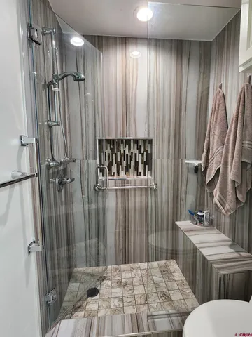 a bathroom with a sink toilet and shower