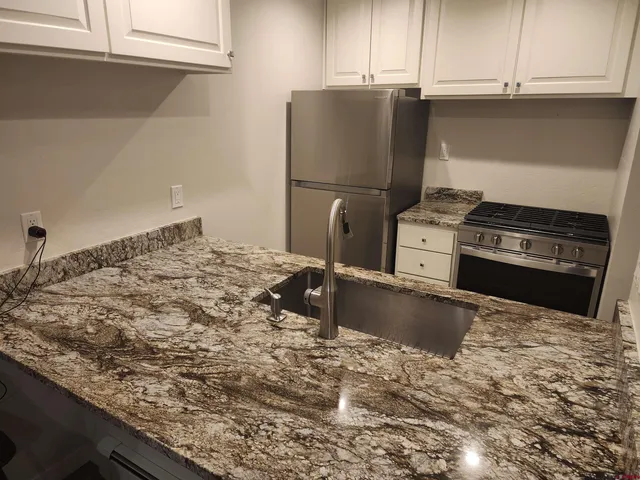 a kitchen with a stove and a refrigerator