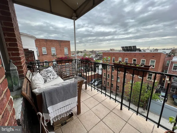 a view of city from balcony with seating space