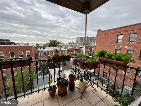 a view of a chairs and table in the balcony