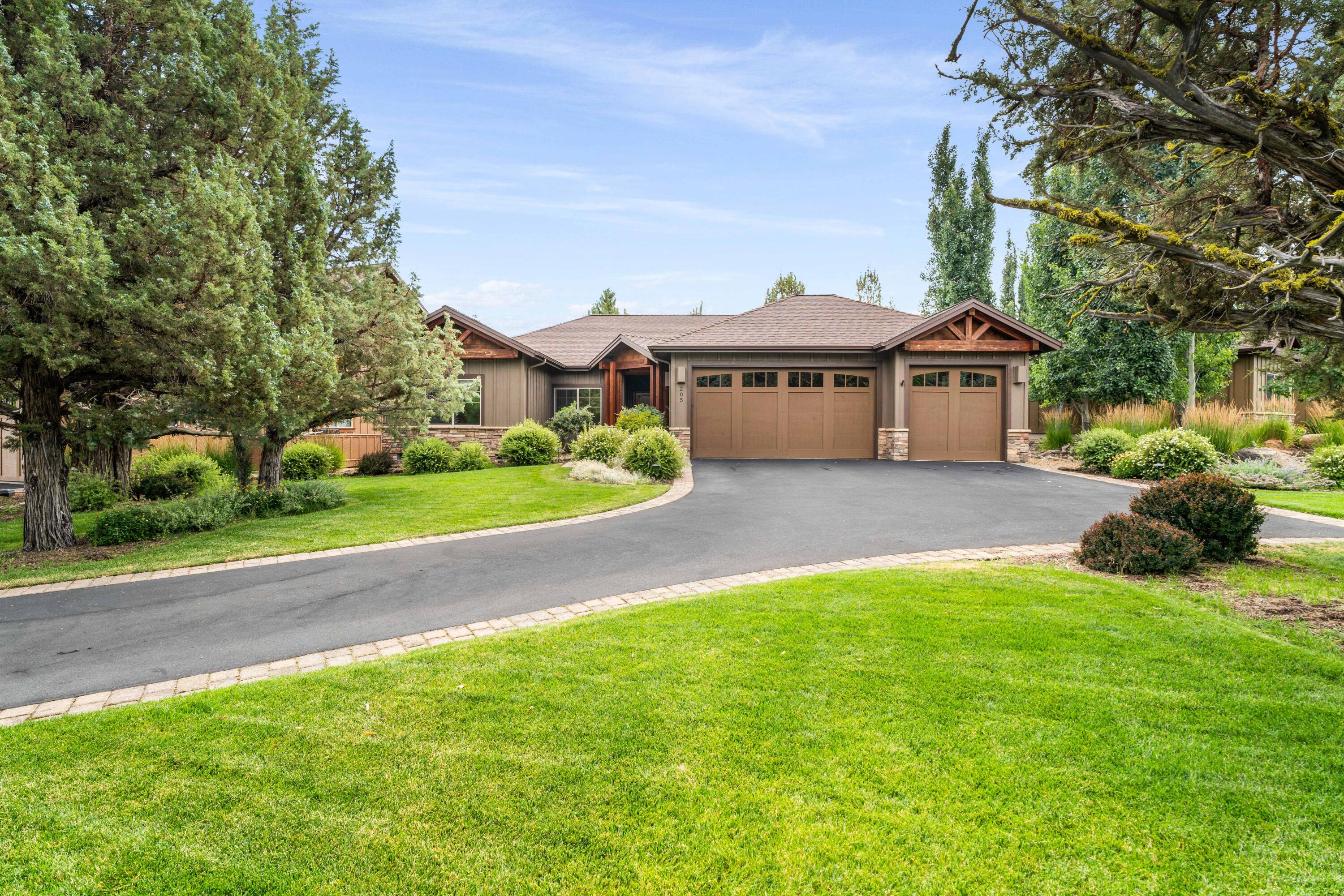 205 Vista Rim Drive Redmond, OR 97756 - Photo 1 of 85 a view of a house with a big yard and potted plants and large trees