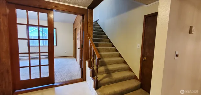 a view of entryway and hall with wooden floor