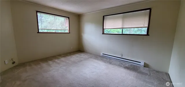 a view of an house with backyard and trees