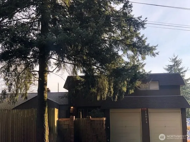 a view of a house with a tree