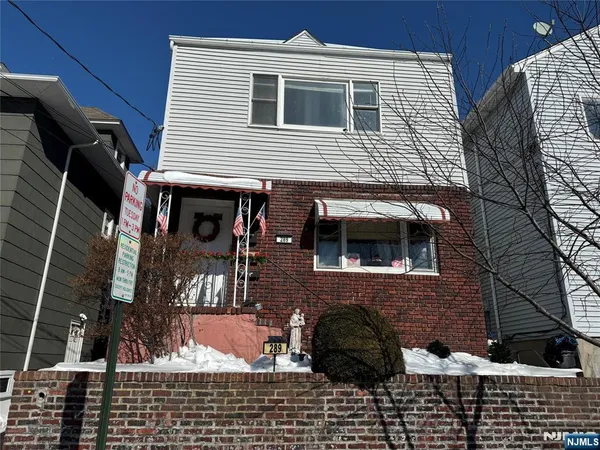 a view of house with a window and car parked