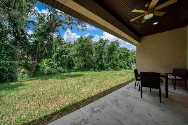 a view of a porch with furniture and garden
