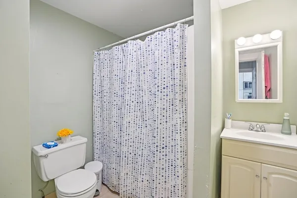 a bedroom with a bed and a chair