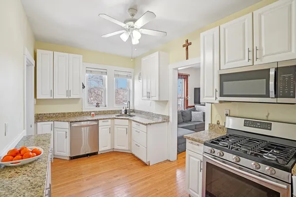 a view of a white house with a yard covered in snow
