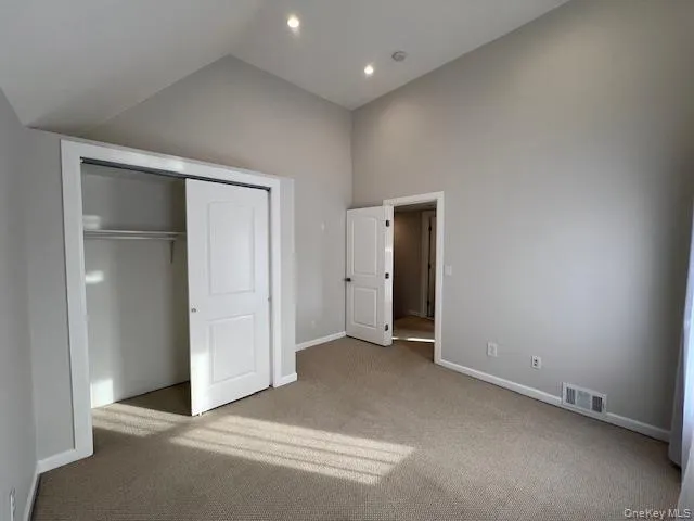 an empty room with windows and closet