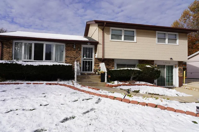 a view of the house with snow on the road