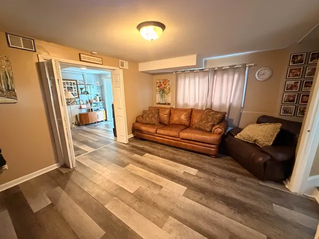 a view of a livingroom with kitchen and bathroom
