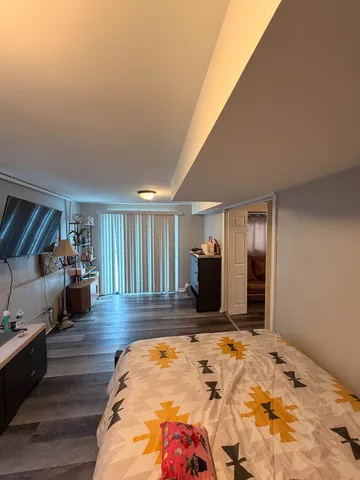 a view of a house with a yard and large trees