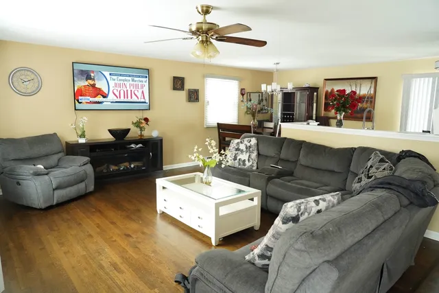 a living room with furniture and a flat screen tv