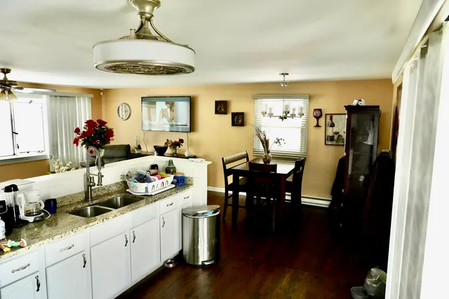 a very nice looking dining room with furniture window and wooden floor