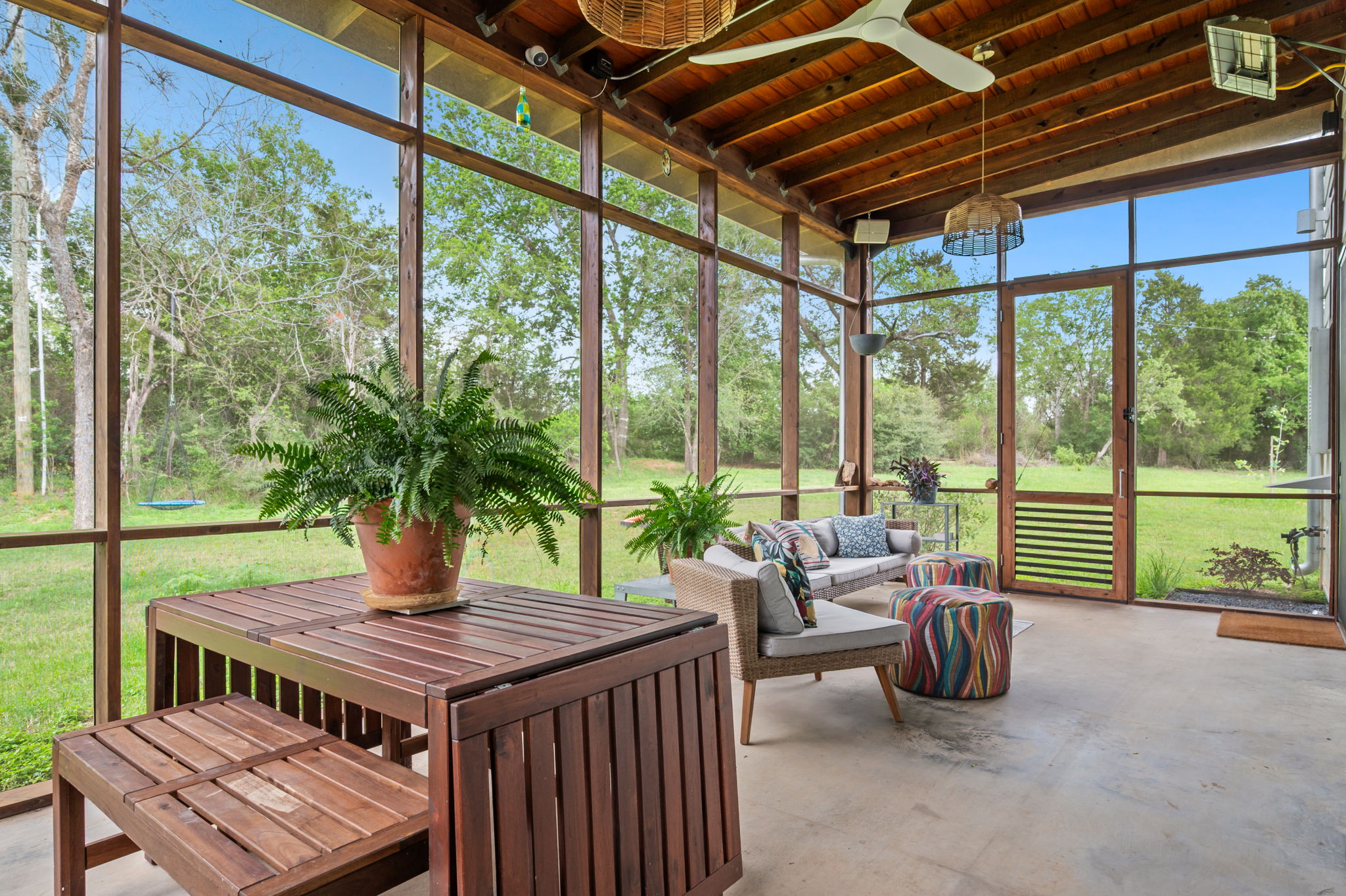 534 Old McDade Road Elgin, TX 78621 - Photo 21 of 40 Screened in porch at back of house has beautiful views of the property and adds a mosquito-free option to outdoor entertaining.