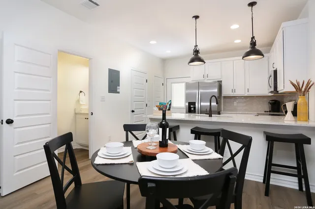 a kitchen with stainless steel appliances kitchen island a refrigerator sink and microwave