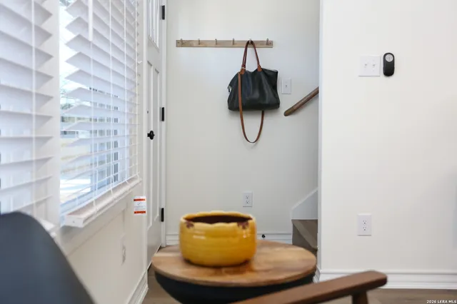 a living room with stainless steel appliances furniture and a dining table