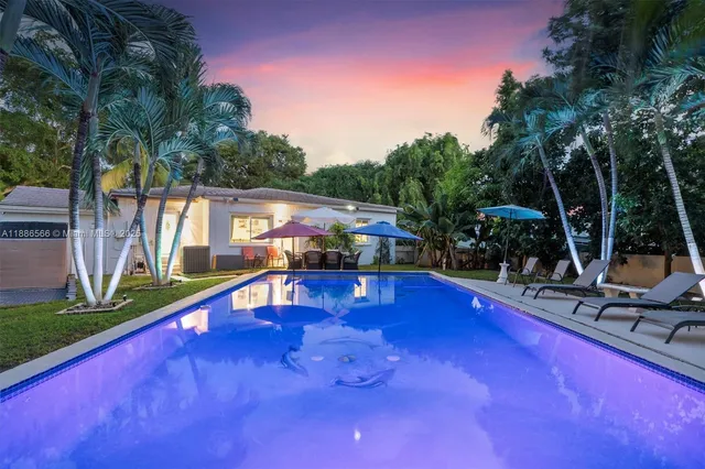 a view of swimming pool with seating area and furniture