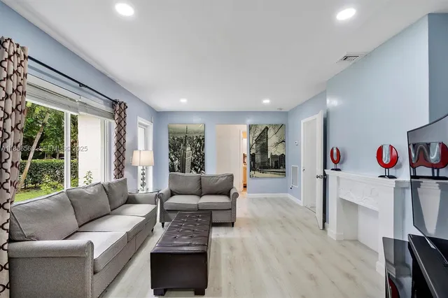 a living room with furniture and a large window