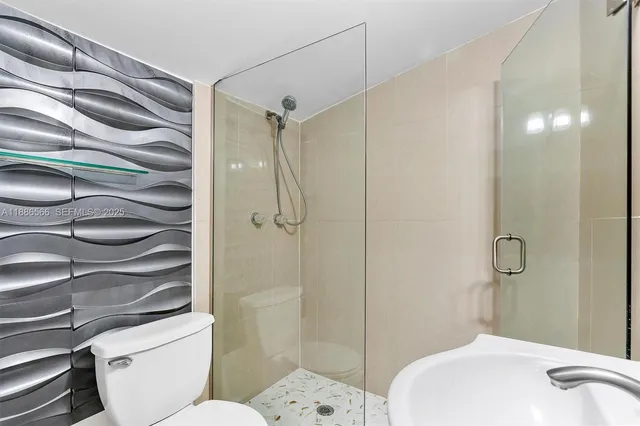 a bathroom with a toilet and a shower