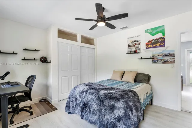 a bed room with a bed and a chair