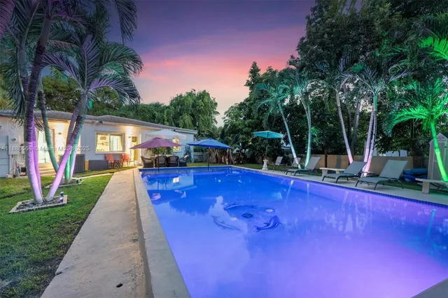 a view of swimming pool with sitting area and garden