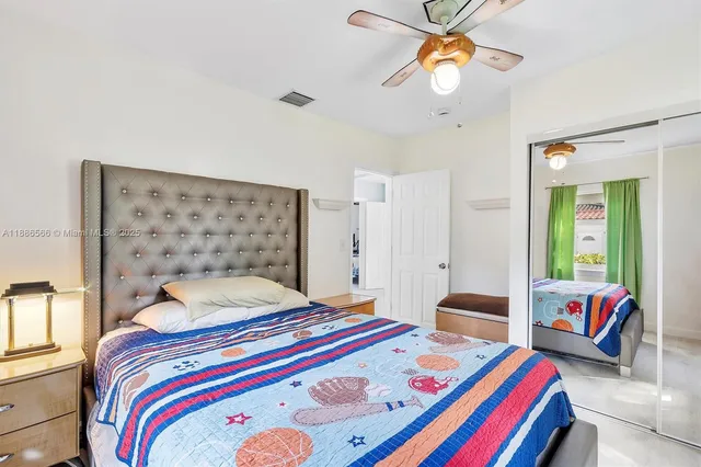 a bedroom that has a bed and a chandelier
