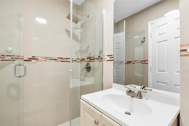 a bathroom with a sink a shower and a mirror