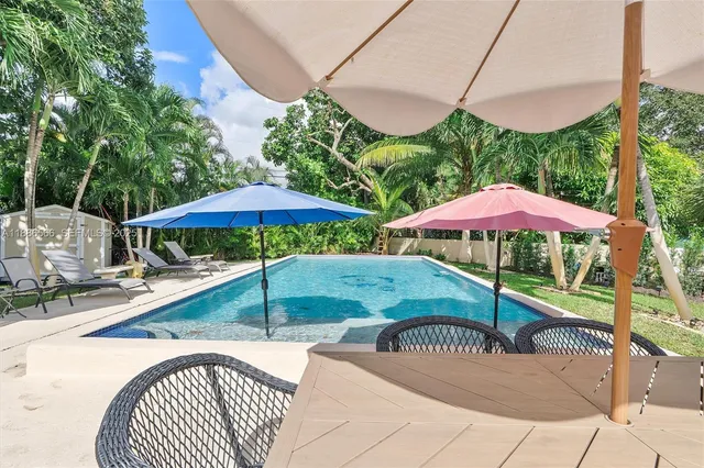 a view of a table and chairs under an umbrella in the patio
