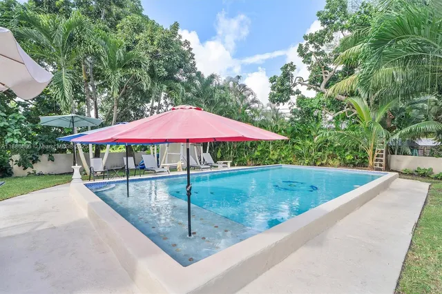 a view of a backyard with a patio and fire pit