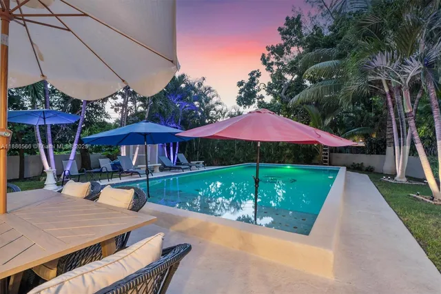 an outdoor space with pool and furniture
