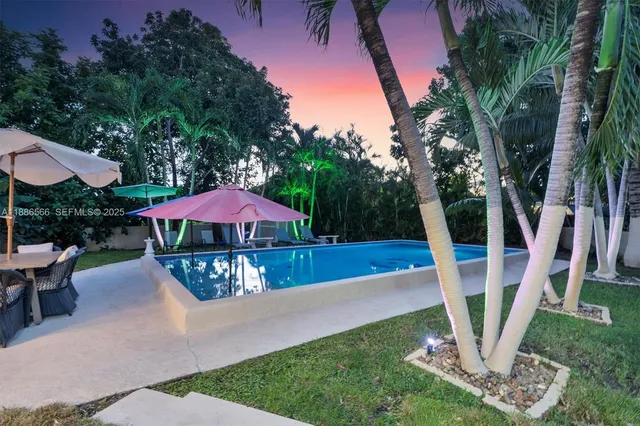 a view of a house with backyard and sitting area