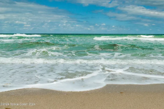 a view of a roof deck with furniture