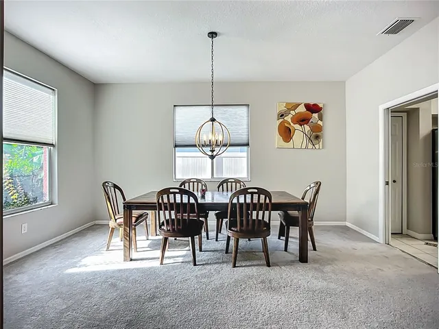 a view of a dining room with furniture window and outside view