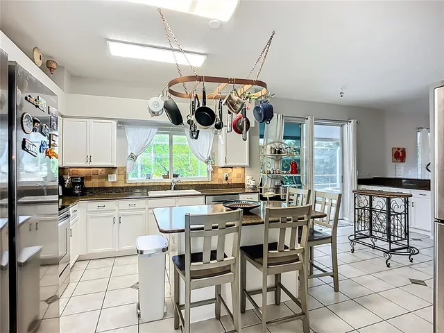 a kitchen with stainless steel appliances granite countertop a sink and cabinets