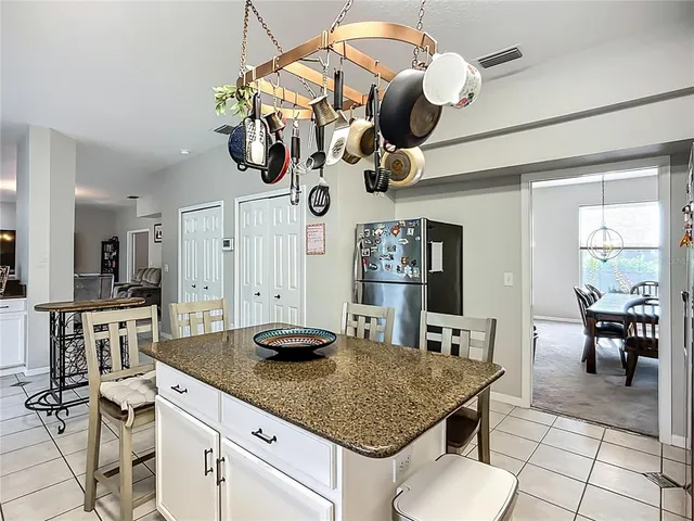 a kitchen with a table chairs and white cabinets