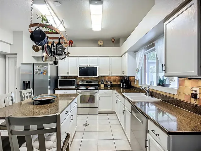 a kitchen with a sink stainless steel appliances and cabinets