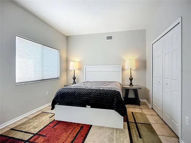 a bedroom with a bed and a window