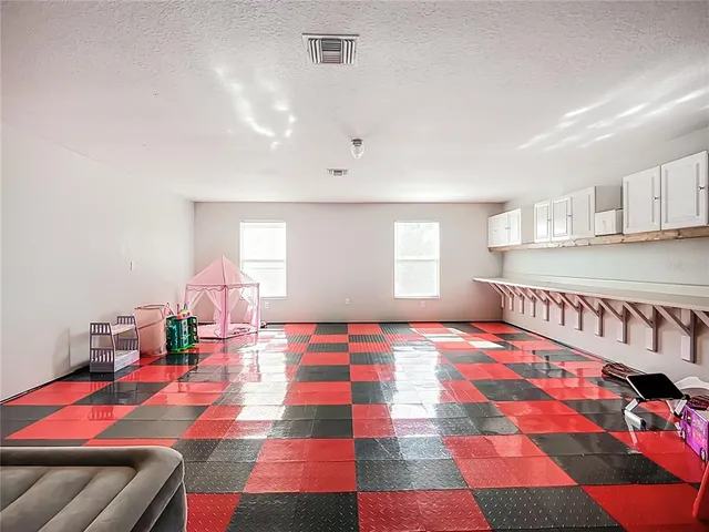 a view of a room with lots of furniture and clutter