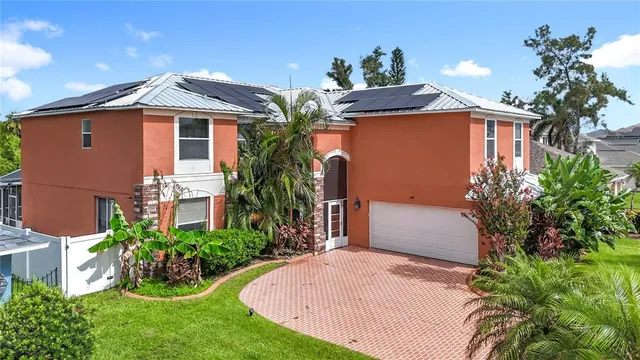 a front view of house with yard and trees around