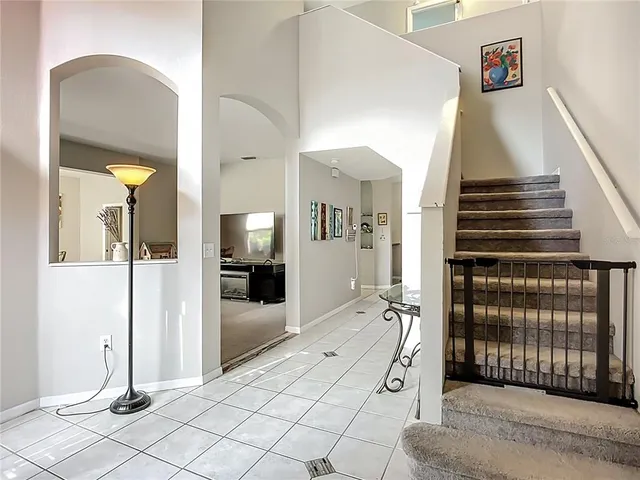 a view of an entryway with wooden floor and a livingroom view