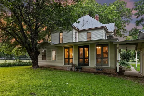 a view of a brick house with a yard next to a big yard