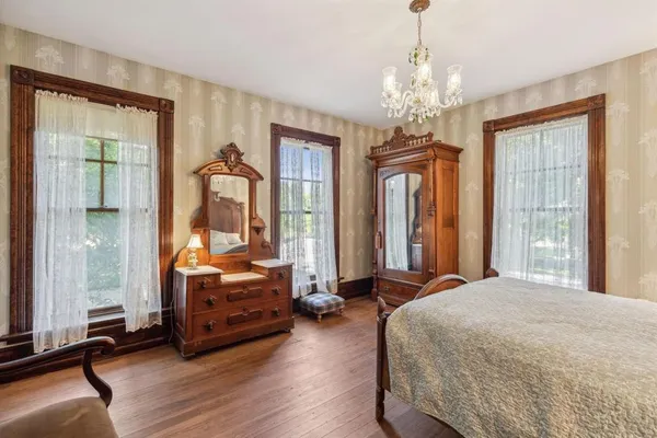 a bedroom with bed and window